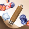 A stylish vape pen with a textured brown design, surrounded by blueberries, ice cubes, and sliced plums. The background features a gradient from light to cream.