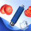 A blue e-cigarette device is placed against a gradient background, surrounded by sliced strawberries and a cube of ice. The device features a textured design and a clear bottom.