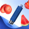 A blue vape device is surrounded by slices of strawberries and watermelon, set against a light blue background.