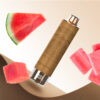 A vape device surrounded by slices of watermelon and pink gummy-like candies on a textured brown background.