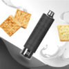 A black, cylindrical vape device with a digital display is surrounded by two crackers and splashes of milk on a textured grey surface.