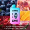 A vape device with a gorilla logo and the text "BANG LEADER 32000 PUFFS" surrounded by images of blueberries, raspberries, peach, mango, and watermelon with the flavor description "Blueberry Raspberry Peach Mango Watermelon".