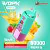 A promotional image for the VOPK Triple vaping device featuring a colourful design and illustrations. The device offers three flavours—Banana Pineapple, Red Bull Ice, and Strawberry Mango—and promises 60,000 puffs. It has a teal and magenta body, stylized graphics, and a lion mascot wearing sunglasses and a cap.