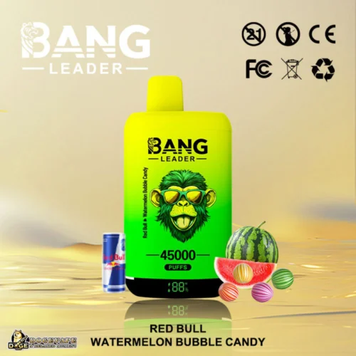 A Bright Yellow And Green Vaping Device With 'Bang Leader' Branding, Featuring A Monkey Logo Wearing Sunglasses, Labeled For 45,000 Puffs In Red Bull &Amp; Watermelon Bubble Candy Flavour, Displayed With A Small Red Bull Can, Watermelon, And Candy On A Reflective Surface.