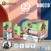 Disposable vape device and packaging in green and pink with a chimpanzee wearing a cap and sunglasses design, advertising 6000 puffs with triple flavor: blueberry raspberry, strawberry kiwi, and lemon lime, displayed on a surface against a colorful backdrop with brand logos and vaping features icons.