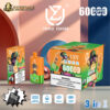 Disposable UZY vape device and packaging featuring cartoon monkey with sunglasses, advertising triple flavor and 600 puffs, with nicotine warning and technical icons for triple mesh coil, 54ml capacity, 850mAh battery, and Type-C port against colourful geometric background.