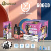 Vape product packaging and device featuring cartoon monkey illustrations, highlighting triple flavor of kiwi passion fruit guava, blueberry ice, and peach mango with 6000 puffs capacity, 54ml liquid, 850mAh battery, and type-C charging port on a colourful abstract background.