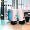 Two pink Bang King vape devices with black bases featuring fruit illustrations and a cartoon monkey, displayed on a desk in front of a laptop with a cityscape visible through large windows behind.