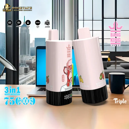 Two Pink Bang King Vape Devices With Black Bases Featuring Fruit Illustrations And A Cartoon Monkey, Displayed On A Desk In Front Of A Laptop With A Cityscape Visible Through Large Windows Behind.