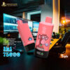 Two pink vape devices with black bases on a dark desk in a modern office, one with a monkey graphic and 'Strawberry Watermelon' text and the other with blueberry graphics and 'Blue Razzie' text, with multiple computer monitors and office chairs in the background.