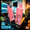 Two pink disposable vape devices labeled Blue Razz Ice and Strawberry Watermelon with graphic designs, set against a modern computer workstation background with multiple monitors and a chair.